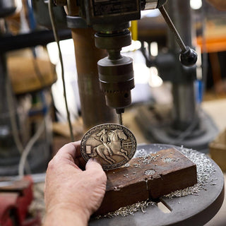Craftsman working on Jessicas Pride Belt Buckle at Buckingham Pewter workshop