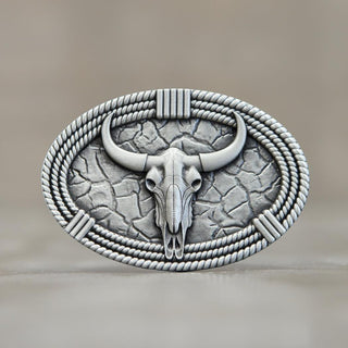Rustic western skull belt buckle featuring a decorative bull skull surrounded by rope details